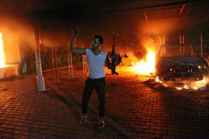 An armed man waves his rifle as buildings and cars are engulfed in flames after being set on fire inside the US consulate compound in Benghazi late on September 11, 2012. The capture of an alleged leader of the deadly 2012 attacks on Americans in Benghazi, Libya, gave U.S. officials a rare moment of good news. Now, they are preparing to try the captured Libyan in the U.S. court system. File photo from the scene of the explosion by STR/AFP/GettyImages