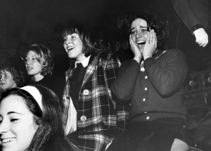 Fans gleefully watch the Beatles perform on "The Ed Sullivan Show" in February 1964. Photo by Central Press/Getty Images