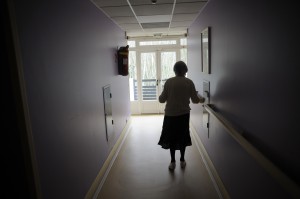 A woman, suffering from Alzheimer's desease, walks in a corridor on March 18, 2011 in a retirement house in Angervilliers, eastern France. AFP PHOTO / SEBASTIEN BOZON (Photo credit should read SEBASTIEN BOZON/AFP/Getty Images)