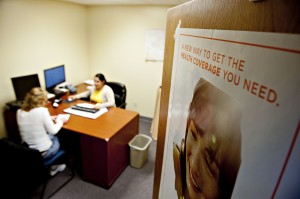 Samantha Guzman, an Affordable Care Act navigator with the Bureau and Putnam County Health Department, center, assists Jackie Karns as she shops for health insurance at the Bureau County Health Department offices in Princeton, Illinois, U.S., on Wednesday, Dec. 18, 2013. Karns has a full time job, but her employer does not offer health insurance. Consumers who enroll in health plans through the new U.S. exchanges will get 10 extra days to pay their first premiums and still gain coverage effective Jan. 1, an insurance company trade group announced. Photographer: Daniel Acker/Bloomberg *** Local Caption *** Jackie Karns; Samantha Guzman