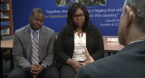 Daniel Alexandre and Shaquilla Boyce speak to Paul Solman. Eye contact is just one of the soft skills that Year Up emphasizes. NewsHour still shot.