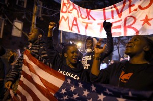 Caption:ST. LOUIS, MO - NOVEMBER 23: Demonstrators march through the streets while protesting the shooting death of 18-year-old Michael Brown on November 23, 2014 in St. Louis, Missouri. Tensions in Ferguson remain high as a grand jury is expected to decide this month if Ferguson police officer Darren Wilson should be charged in the shooting death of Michael Brown. (Photo by Justin Sullivan/Getty Images)