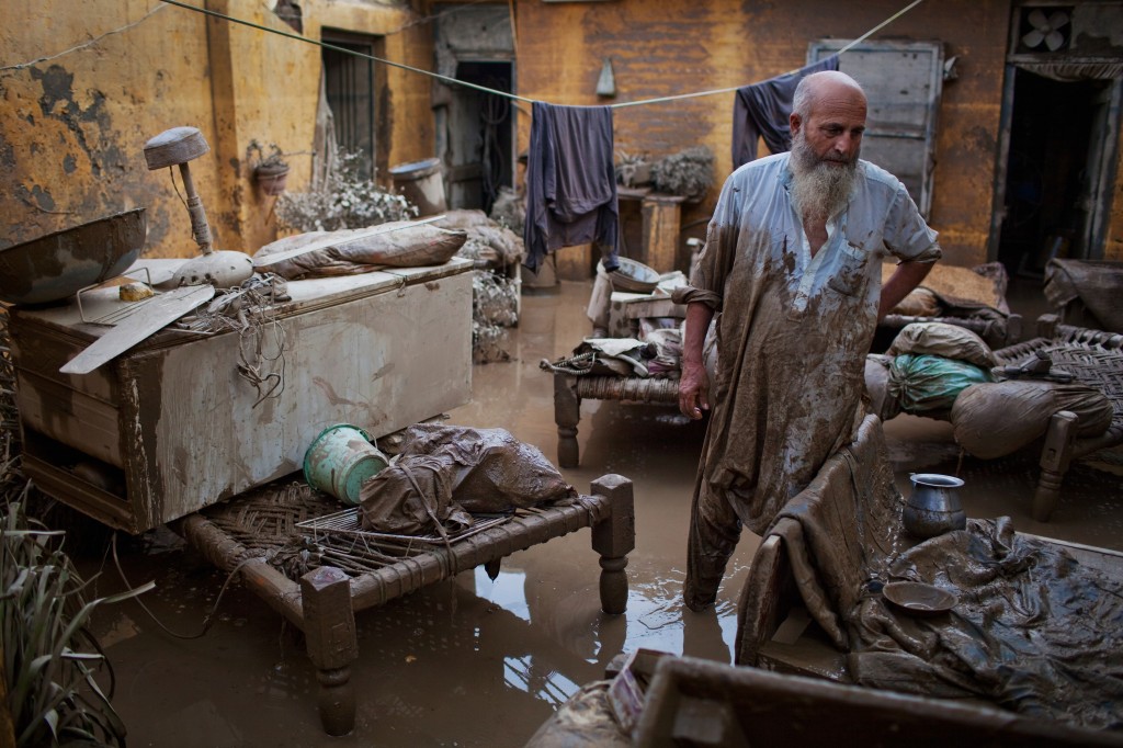 A man surveys the damage to his home in Nowshera, Pakistan. Photo by Daniel Berehulak/Getty Images