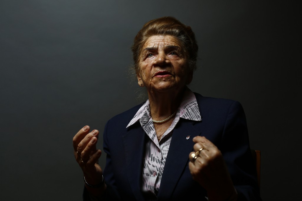 Auschwitz death camp survivor Maria Stroinska gestures as she poses for a portrait in Warsaw