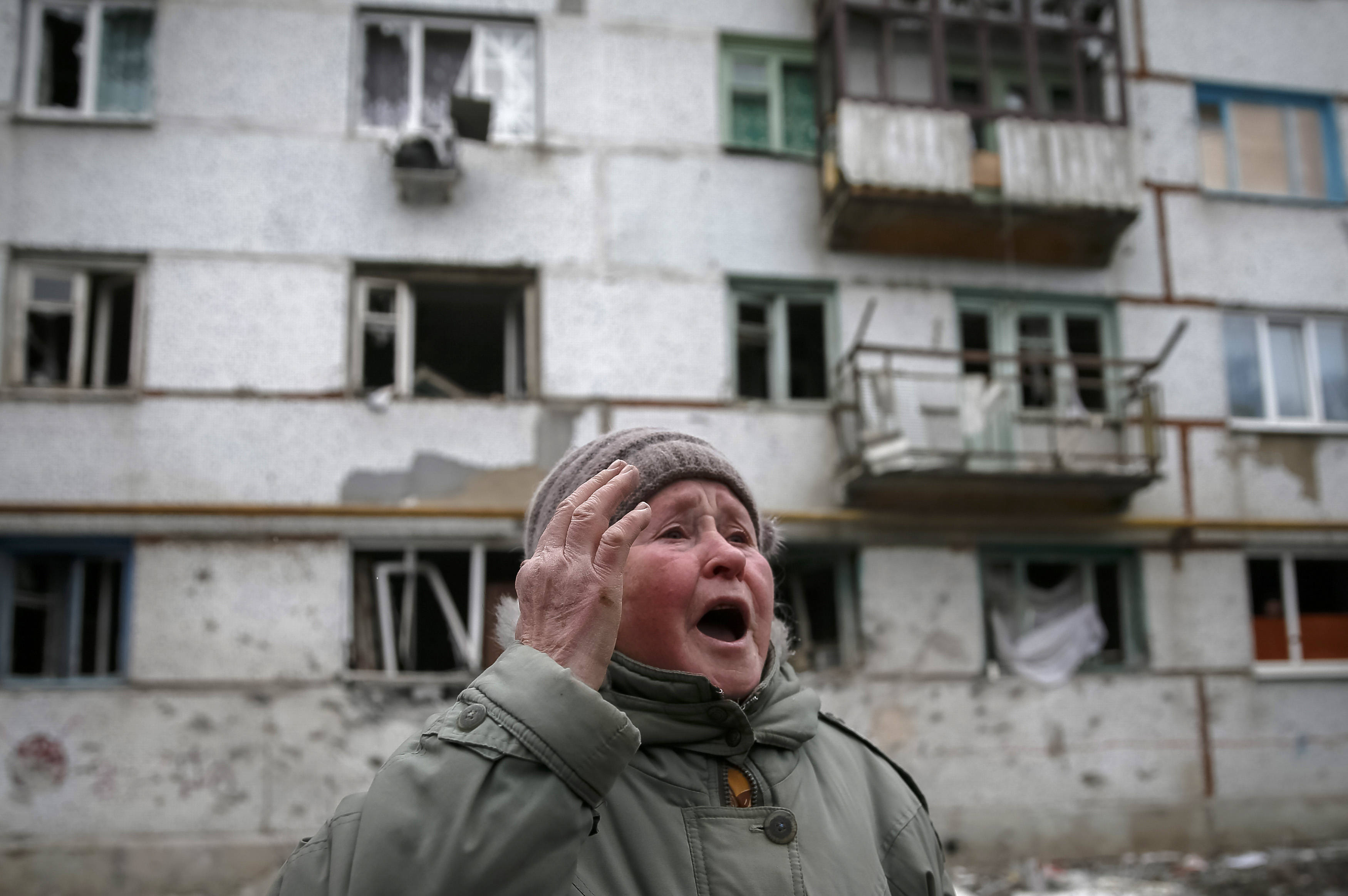 A local resident reacts near her home after shelling in recent days in Svitlodarsk, eastern Ukraine, February 15, 2015. Photo by Gleb Garanich/Reuters