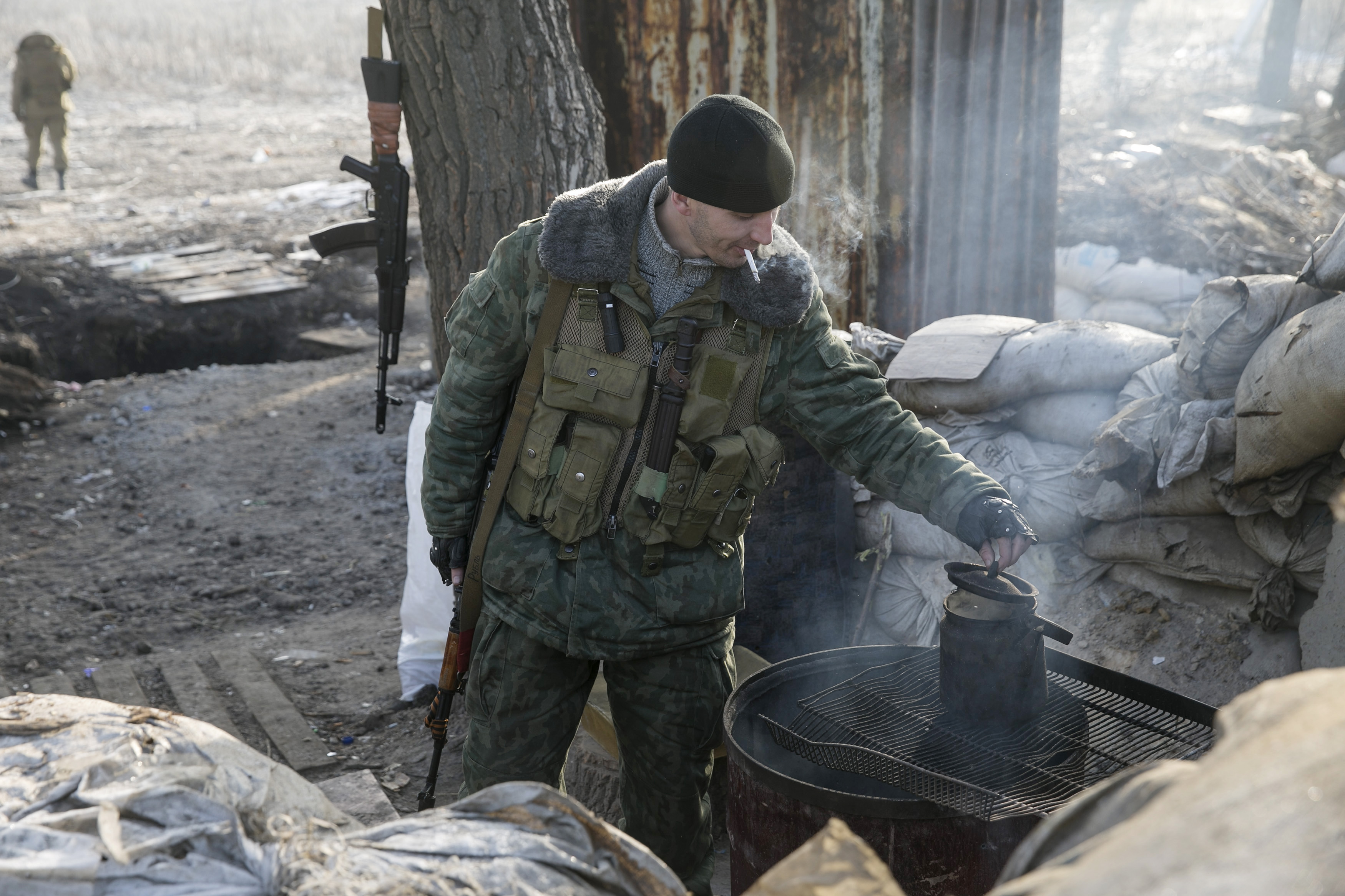 A member of the armed forces of the separatist self-proclaimed Donetsk People's Republic checks on a kettle at a checkpoint near Donetsk, February 15, 2015. Photo by Baz Ratner/Reuters