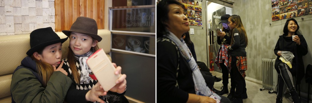 Left: Kim Si-yoon and Yoo Ga-eul, left, take a selfie at a restaurant in Seoul November 15, 2014. Right: Kim Si-yoon, center left, and Yoo Ga-eul look at a smart phone as they take a short break at DEF Dance Skool in Seoul Nov. 7, 2014. Photos by Kim Hong-Ji/Reuters