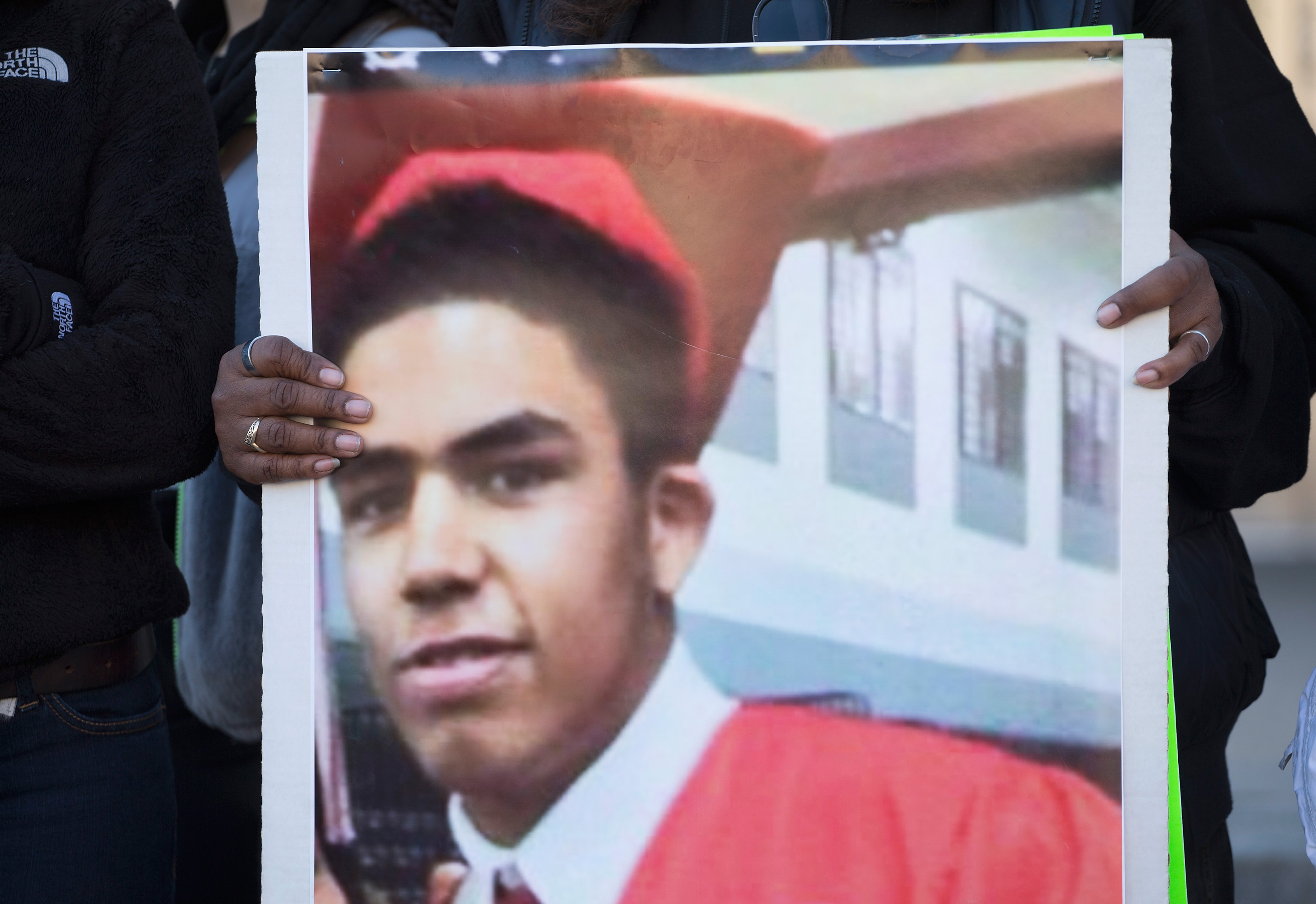 MADISON, WI - MARCH 09: A family member holds a picture of Tony Robinson during a  protest outside of the City Hall building on March 9, 2015 in Madison, Wisconsin. The protestors were angry about the shooting of the 19-year-old Robinson, who was killed by Madison Police Officer Matt Kenny during a confrontation on March 6. The demonstrators also marched through the State Capital building during today's protest.  (Photo by Scott Olson/Getty Images)