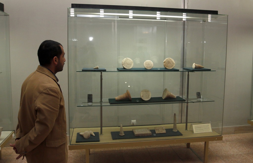 A man looks at artifacts displayed inside the Iraqi National Museum in Baghdad on Feb. 28, 2015. Photo by Khalid al-Mousily/Reuters