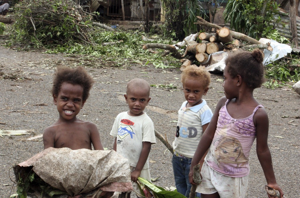 Children stand in front of debris on a street near their homes on March 15, 2015, after Cyclone Pam hit Port Vila, the capital city of the Pacific island nation of Vanuatu. Photo by Kris Paras/Reuters