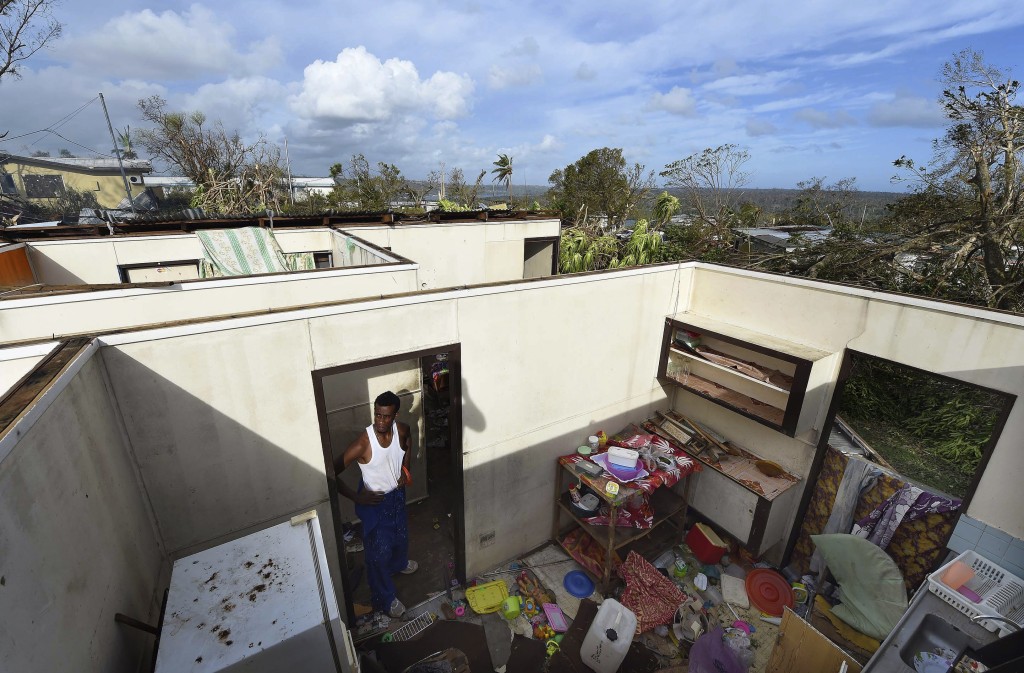 Local resident Uwen Garae stands in his home damaged by Cyclone Pam in Port Vila, the capital city of the Pacific island nation of Vanuatu, on March 16, 2015. Photo by Dave Hunt/Pool/Reuters
