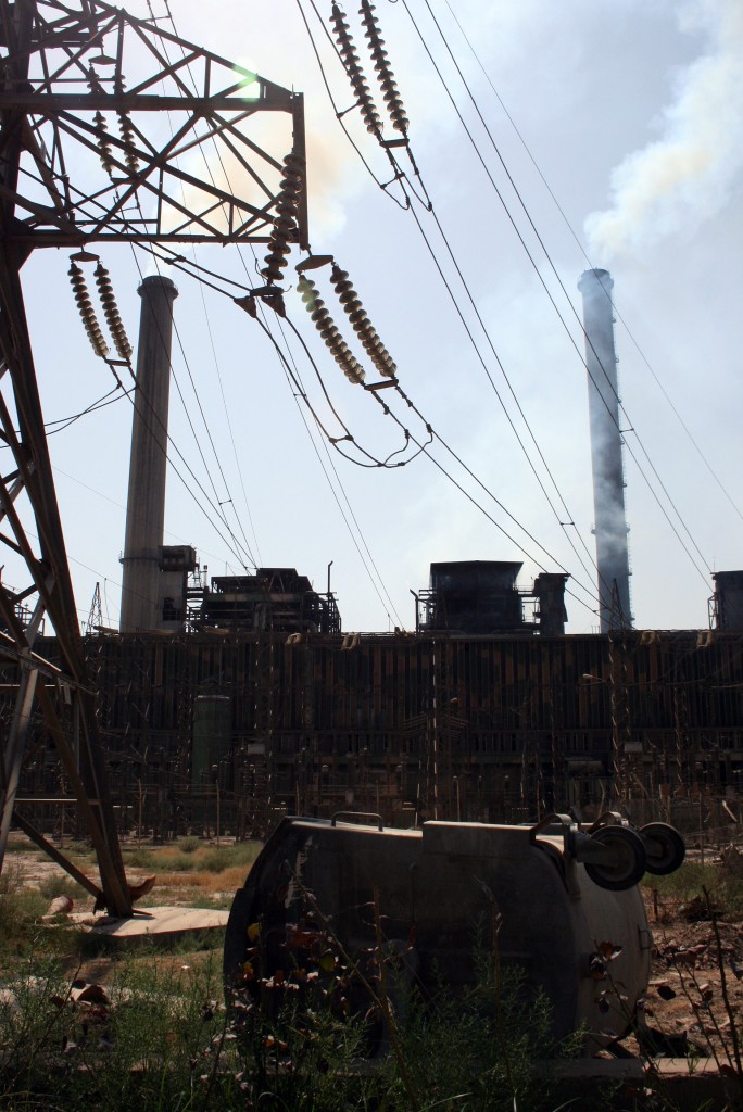 Smokestacks The power plant in Doura has four smokestacks: two from Italy and two from Germany. Discarded equipment and concrete blocks litter the grounds.