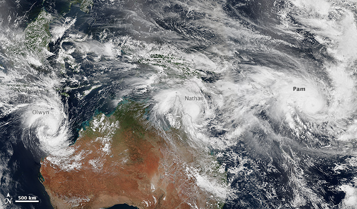 It has been an unusually busy week for tropical cyclones in the vicinity of Australia. This mosaic shows three storms -- Pam, Nathan and Olwyn -- swirling near the continent on March 11, 2015. Image courtesy of NASA