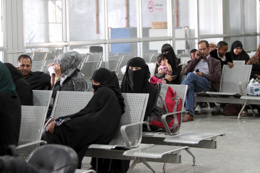 Foreigners and Yemenis wait for their evacuation flight at Sanaa airport on April 13. Photo by Mohamed al-Sayaghi/Reuters