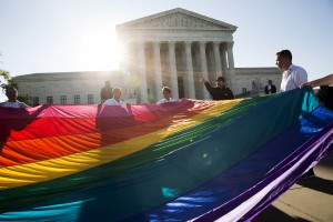 Gay marriage supporters hold a gay rights flag in front of the Supreme Court before a hearing about gay marriage in Washington, D.C. in 2015. Photo by Joshua Roberts/Reuters