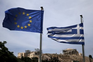 A European Union flag and a Greek national flag flutter as the ancient Parthenon temple is seen in the background in Athens June 1, 2015. Greece and its European creditors agreed on the need to reach a cash-for-reforms deal quickly as Athens missed a self-imposed Sunday deadline for reaching an agreement to unlock aid, sources close to the talks said. Photo by Alkis Konstantinidis/REUTERS