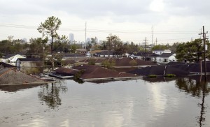 Only the rooftops of houses are seen with the skyline in the background in flooded New Orleans August 30, 2005. Floodwaters engulfed much of New Orleans on Tuesday as officials feared a steep death toll and planned to evacuate thousands remaining in shelters after the historic city's defenses were breached by Hurricane Katrina. REUTERS/Rick Wilking RTW/PN - RTRLZED