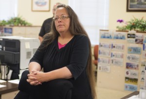 Kim Davis, the Rowan County Clerk of Courts, listens to Robbie Blankenship and Jesse Cruz as they speak with her at the County Clerks Office on September 2, 2015 in Morehead, Kentucky. Citing a sincere religious objection, Davis, an Apostolic Christian, has refused to issue marriage licenses to same sex couples in defiance of a Supreme Court ruling. (Photo by Ty Wright/Getty Images)