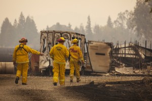 Firefighters survey a destroyed home at the so-called Valley Fire near Middleton, California September 14, 2015. A Northern California wildfire ranked as the most destructive to hit the drought-stricken U.S. West this year has claimed one life and burned at least 400 homes to the ground, fire officials reported on Monday, saying they expected the property toll to climb. Photo by David Ryder/REUTERS