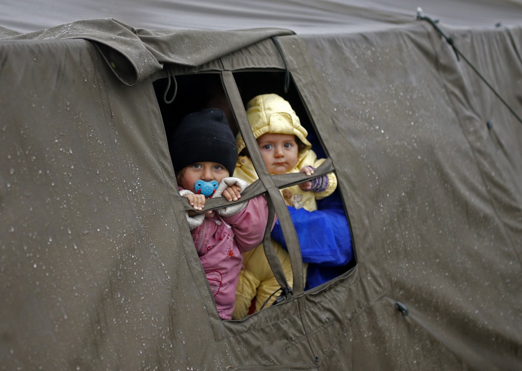 Children look out from a tent at a migrant camp in Opatovac, Croatia, on Oct. 19. Photo by Dado Ruvic/Reuters