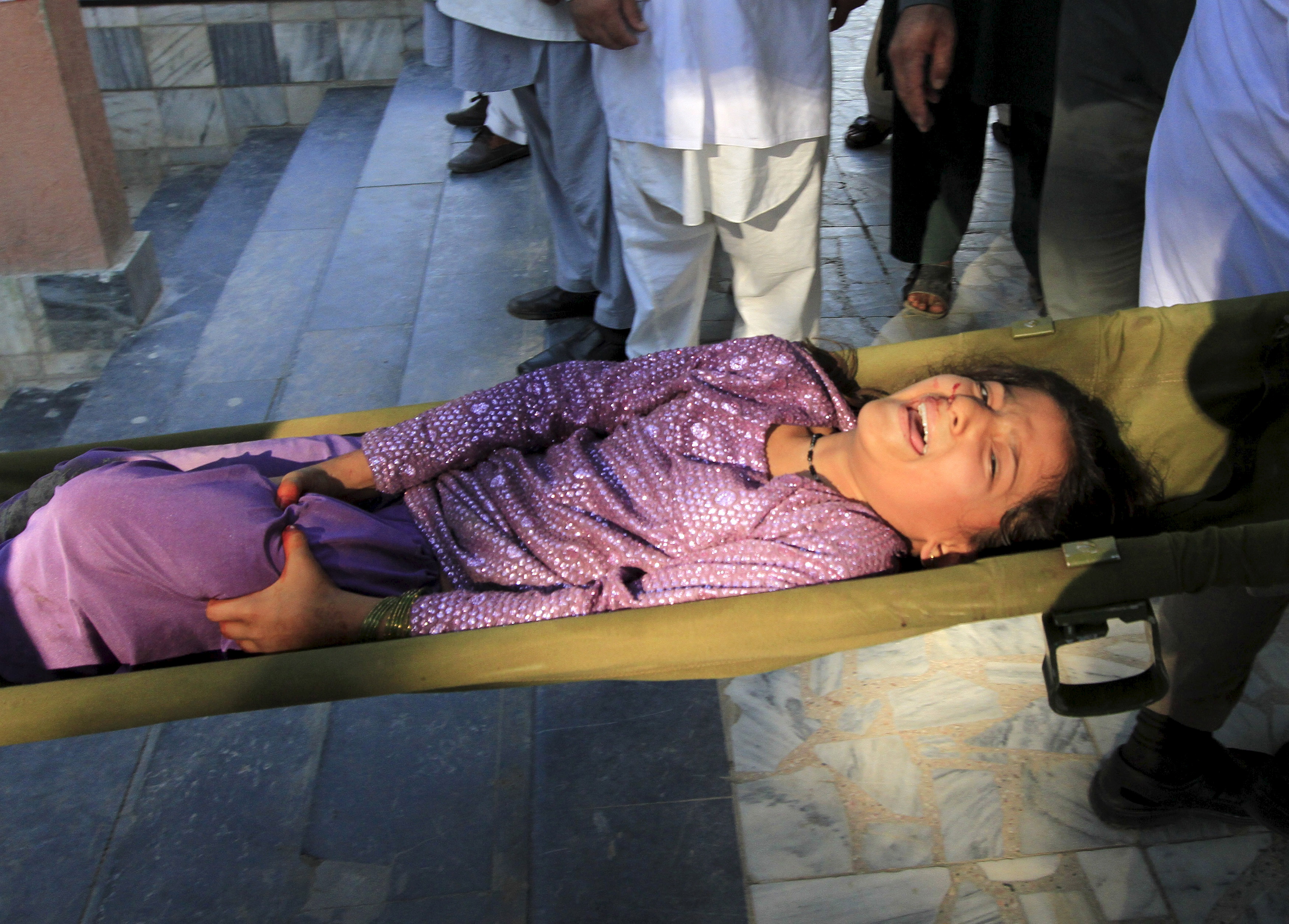 Rescue workers carry a girl who was injured by an earthquake, into a hospital in Jalalabad, Afghanistan, on Oct. 26. Photo by Parwiz/Reuters