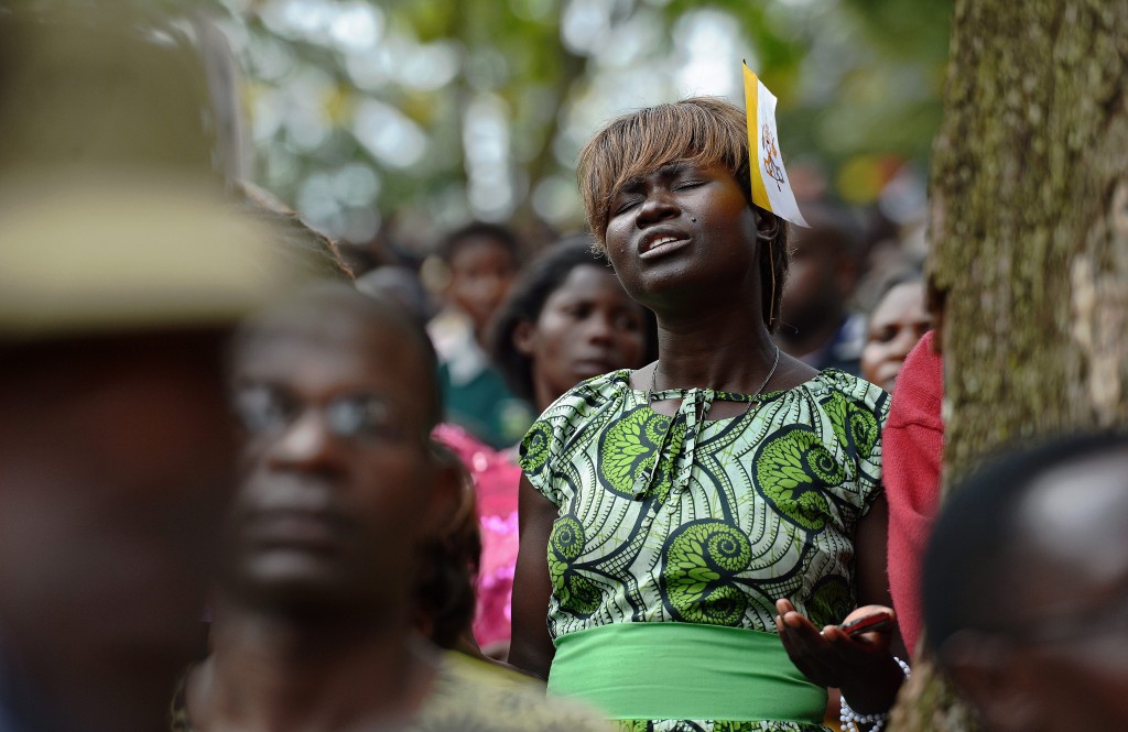 A believer reacts at Namugongo Martyrs' Shrine during an open air mass held by Pope Francis on November 28, 2015.  Pope Francis arrived in Uganda on November 27 on the second leg of a landmark trip to Africa which has seen him railing against corruption and poverty, with huge crowds celebrating his arrival.  / AFP / CARL DE SOUZA        (Photo credit should read CARL DE SOUZA/AFP/Getty Images)