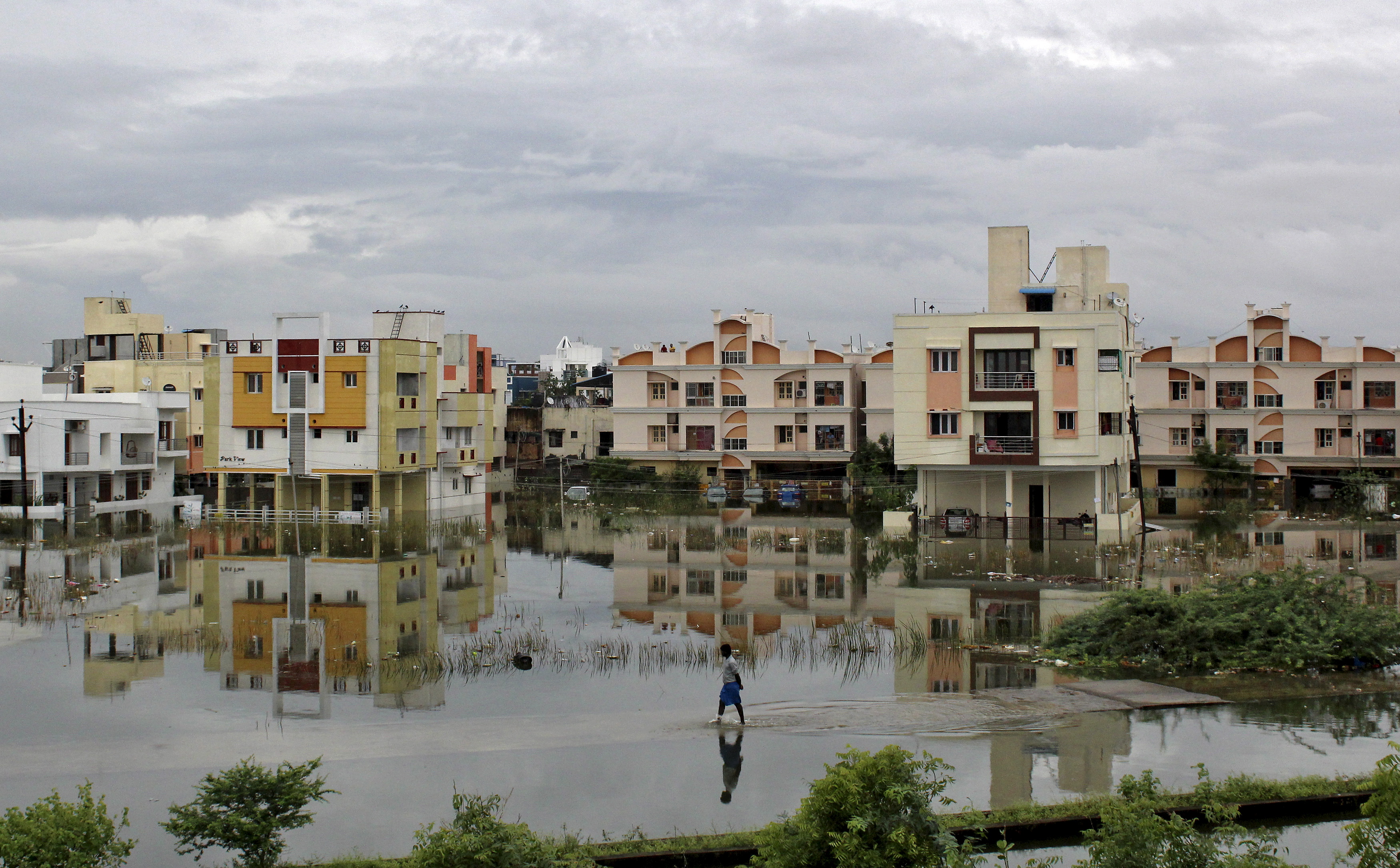 A man walks through a flooded residential area in Chennai, India, on Dec. 2. Photo by Reuters stringer