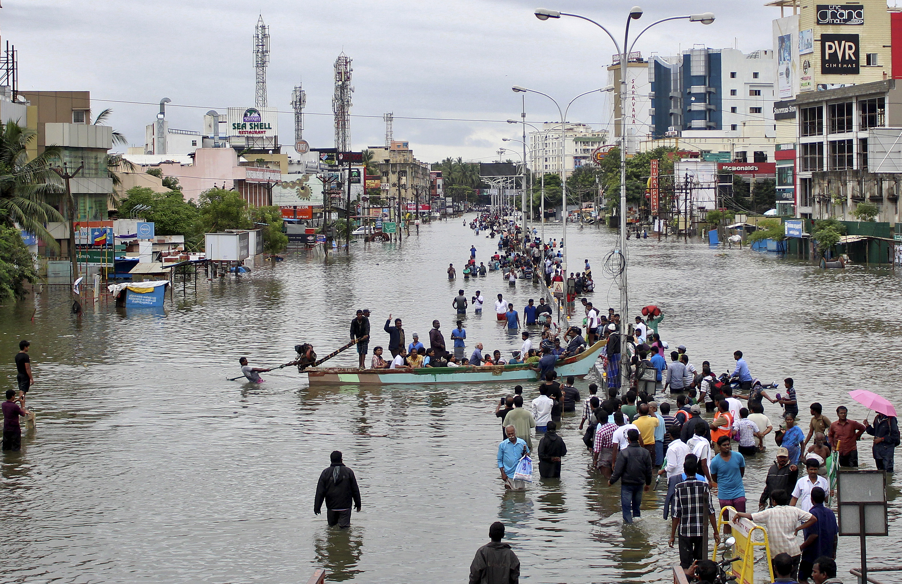 People travel by boat to safer places through a flooded road in Chennai, India, on Dec. 2. Photo by Reuters stringer