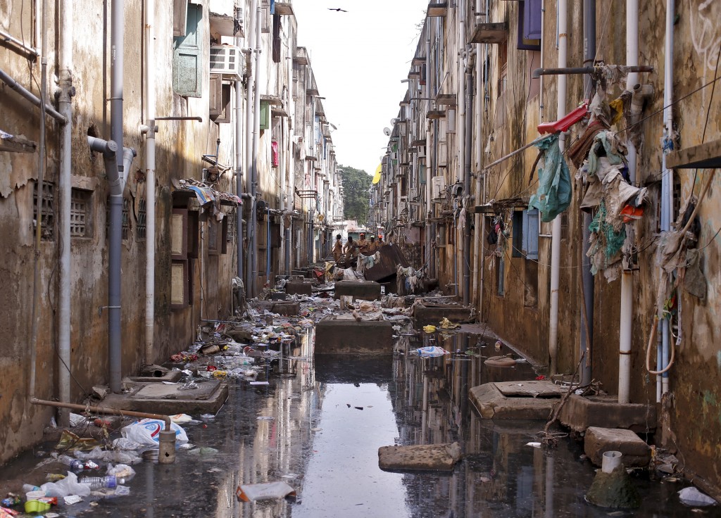 Municipal workers clear the debris in an alley after flood waters receded in Chennai, India, December 7, 2015. REUTERS/Anindito Mukherjee