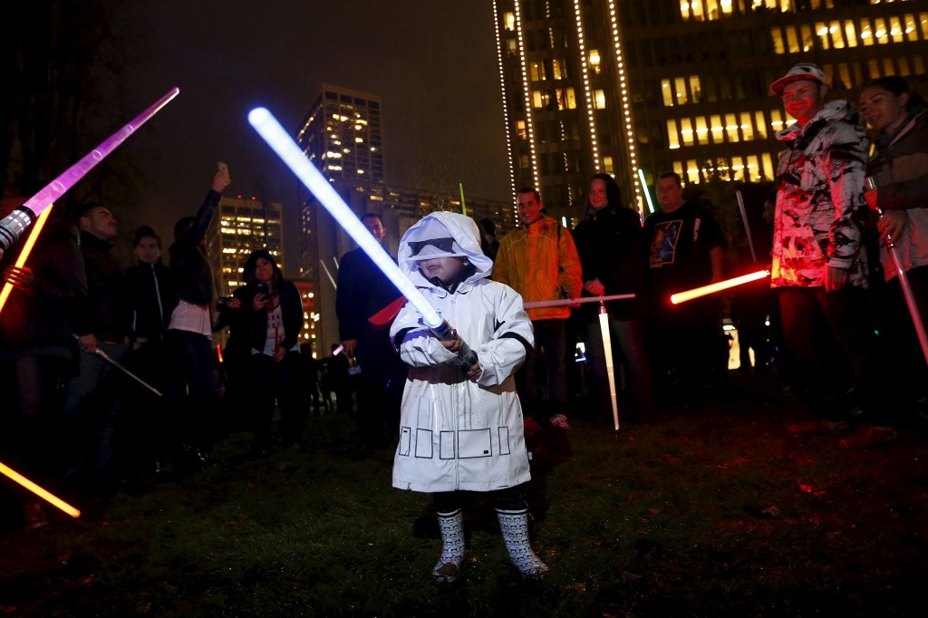 Isaiah Sanchez, 3, of San Francisco, swings a lightsaber during a Star Wars themed lightsaber battle at Sue Bierman Park in San Francisco, California, December 18, 2015. REUTERS/Stephen Lam - RTX1ZCB8