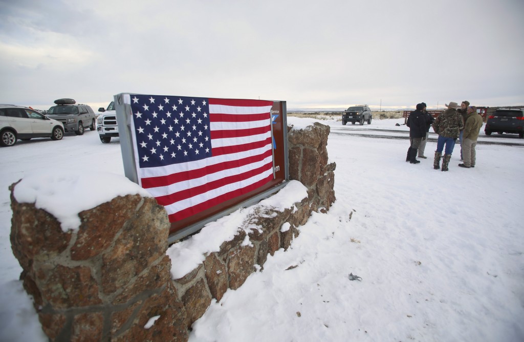 A U.S. flag covers a sign at the entrance of the Malheur National Wildlife Refuge near Burns, Oregon on Jan. 3. Photo by Jim Urquhart/Reuters