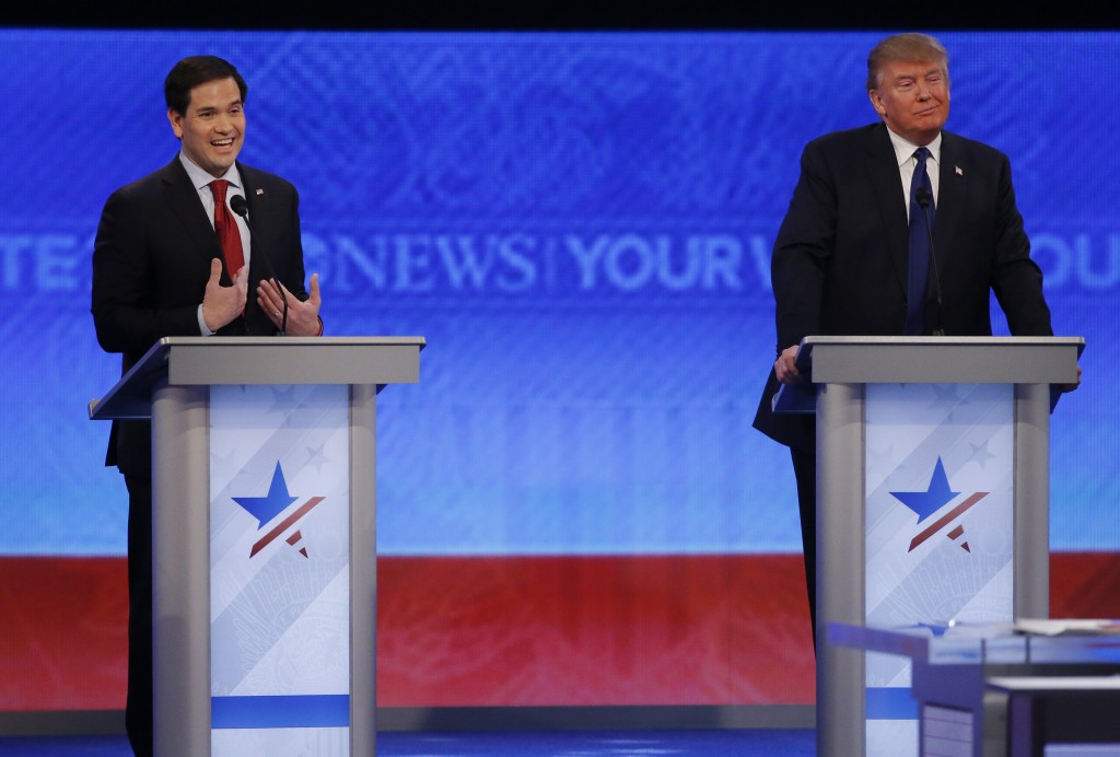 Republican U.S. presidential candidate Senator Marco Rubio (L) reacts to an attack from rival candidate and businessman Donald Trump (R) during the Republican U.S. presidential candidates debate sponsored by ABC News at Saint Anselm College in Manchester, New Hampshire February 6, 2016.     REUTERS/Carlo Allegri - RTX25SML