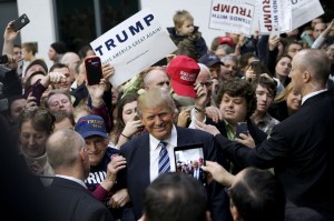 U.S. Republican presidential candidate Donald Trump poses for a photo with a supporter after a campaign rally in Plymouth, New Hampshire, February 7, 2016.  Rick Wilking/Reuters 