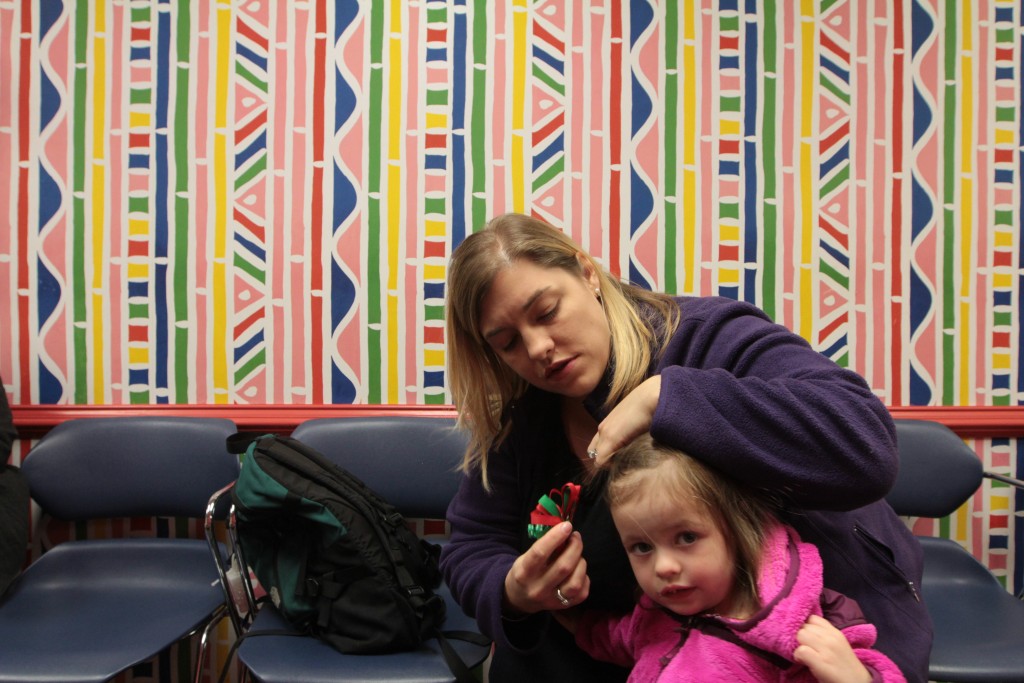 Lauren Shillinger replaces a hairbow for her daughter, Brynleigh, 2, before their two-year check-up with their pediatrician. They plan to discuss Brynleigh's vaccine schedule, and how to administer them in a way that won't prompt fevers and possible seizures. Photo by Joshua Barajas