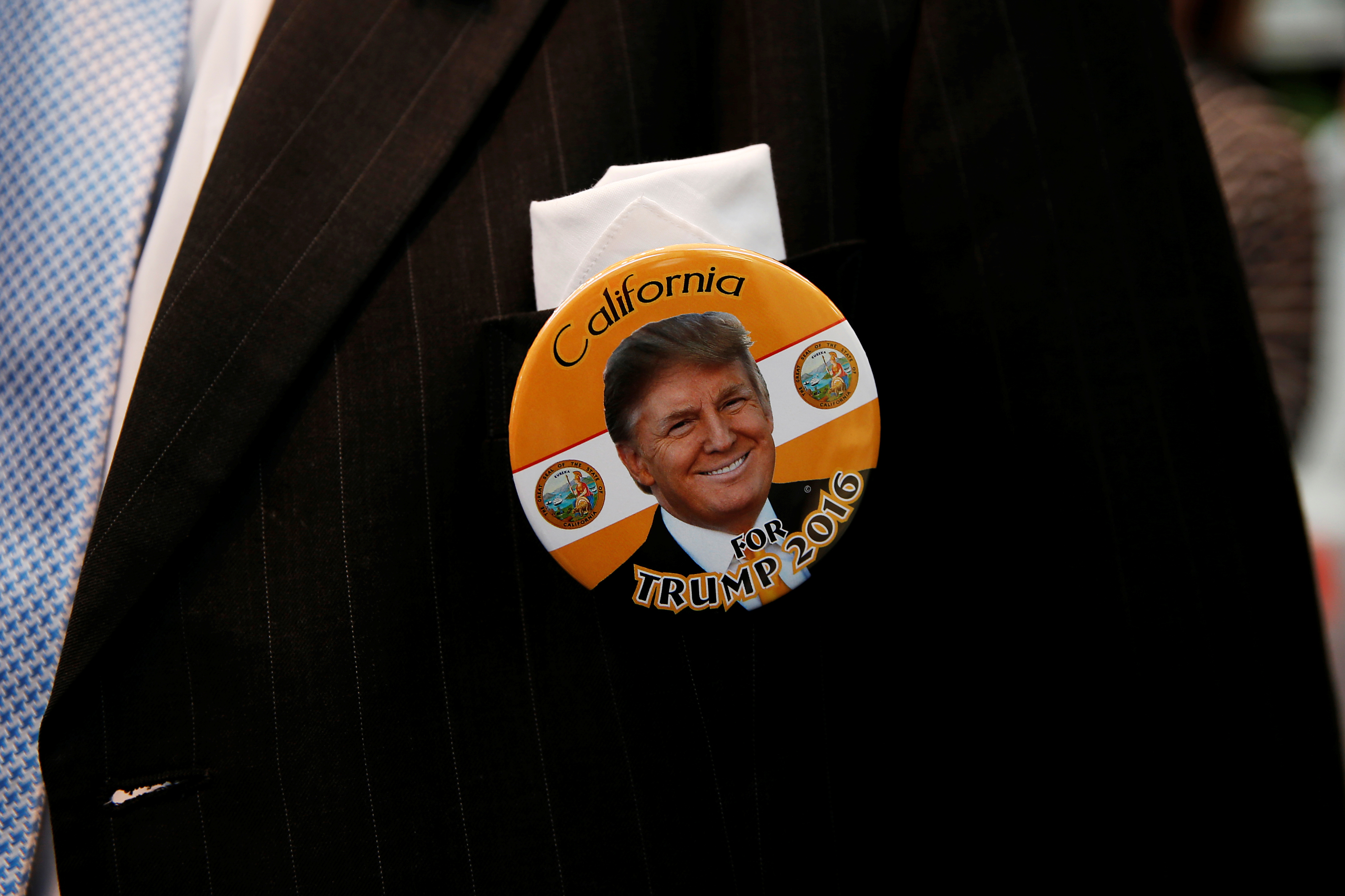 An attendee is seen wearing a pin in support of Republican presidential candidate Donald Trump in Burlingame, California. Photo by Stephen Lam/Reuters