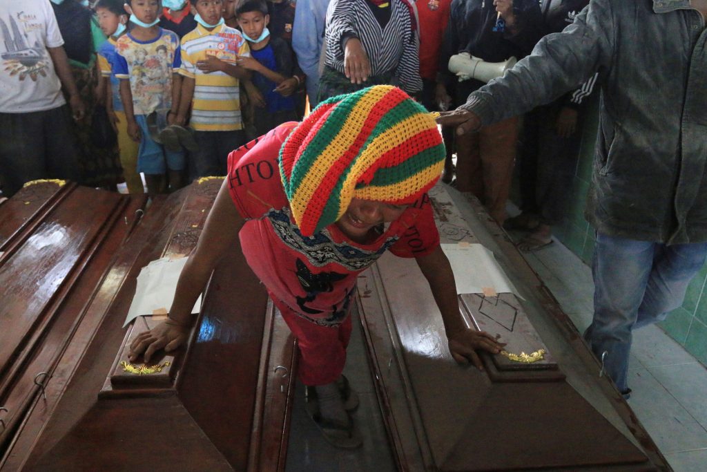 A woman mourns over the coffin of a relative after a deadly eruption of Mount Sinabung, Indonesia May 22, 2016. Photo By Irsan Mulyad via Reuters 