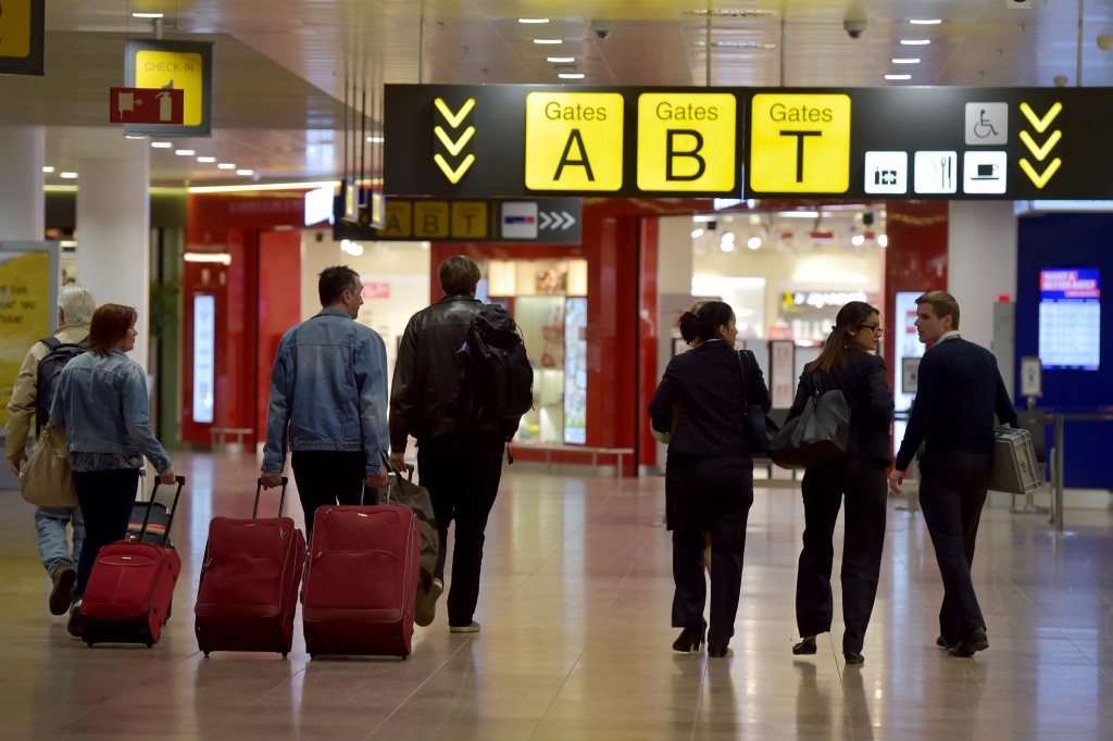 Members of staff and travellers walk in the departure hall after a ceremony at Brussels Airport as it reopens 40 days after deadly attacks in Zaventem, Belgium, May 1, 2016. Photo By Eric Vidal/Reuters