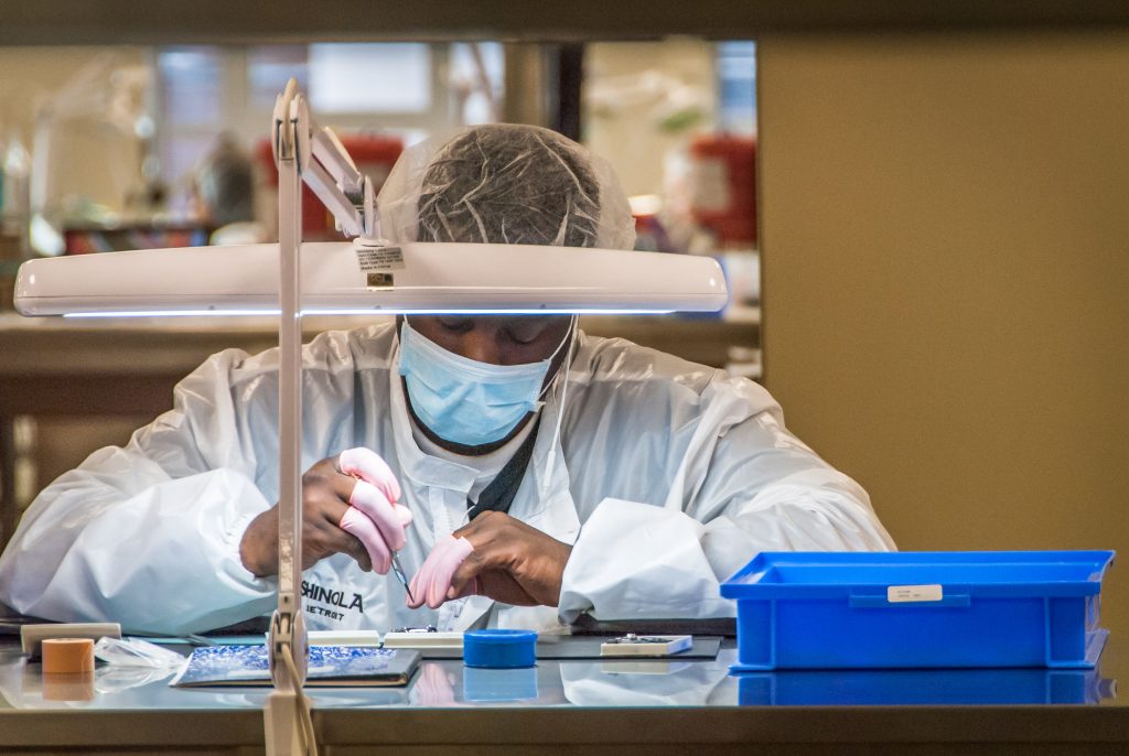 Shinola employee putting together a watch. Photo by Kristen Doerer