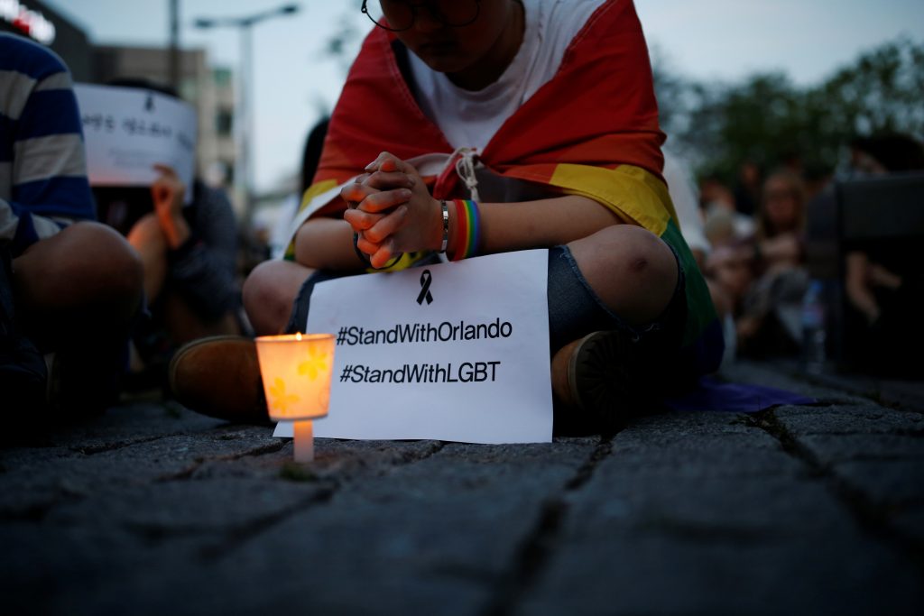 A woman prays during a candlelight vigil in solidarity for the victims of the Orlando gay nightclub mass shooting, in Seoul, South Korea, on June 13. Photo by Kim Hong-Ji/Reuters
