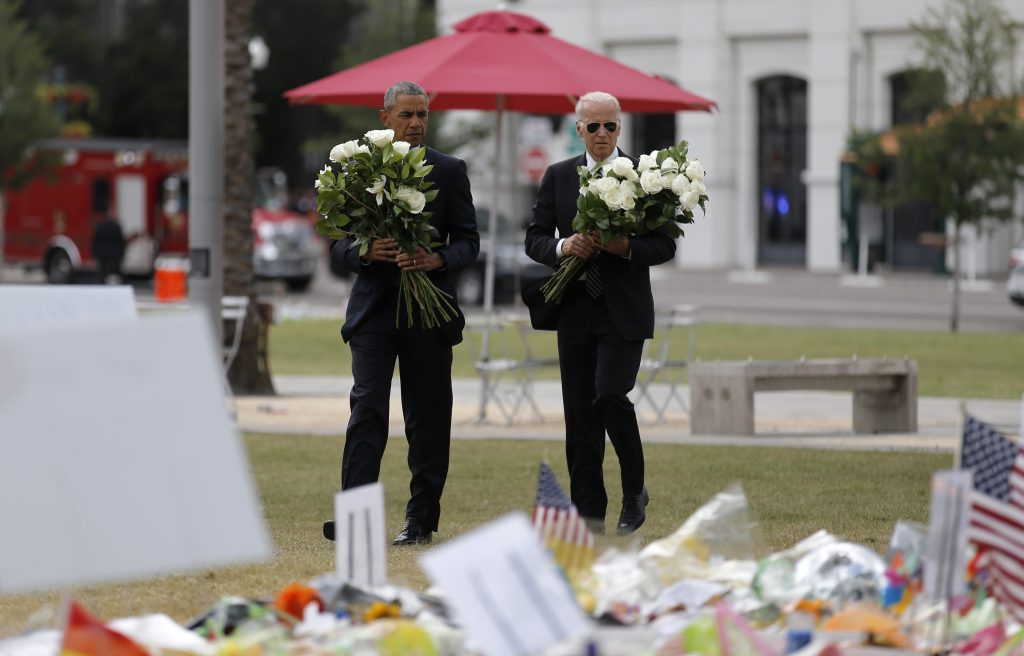 President Barack Obama (L) and Vice President Joe Biden place flowers at a makeshift memorial for shooting victims of the massacre at a gay nightclub in Orlando, Florida. Photo by Carlos Barria/Reuters
