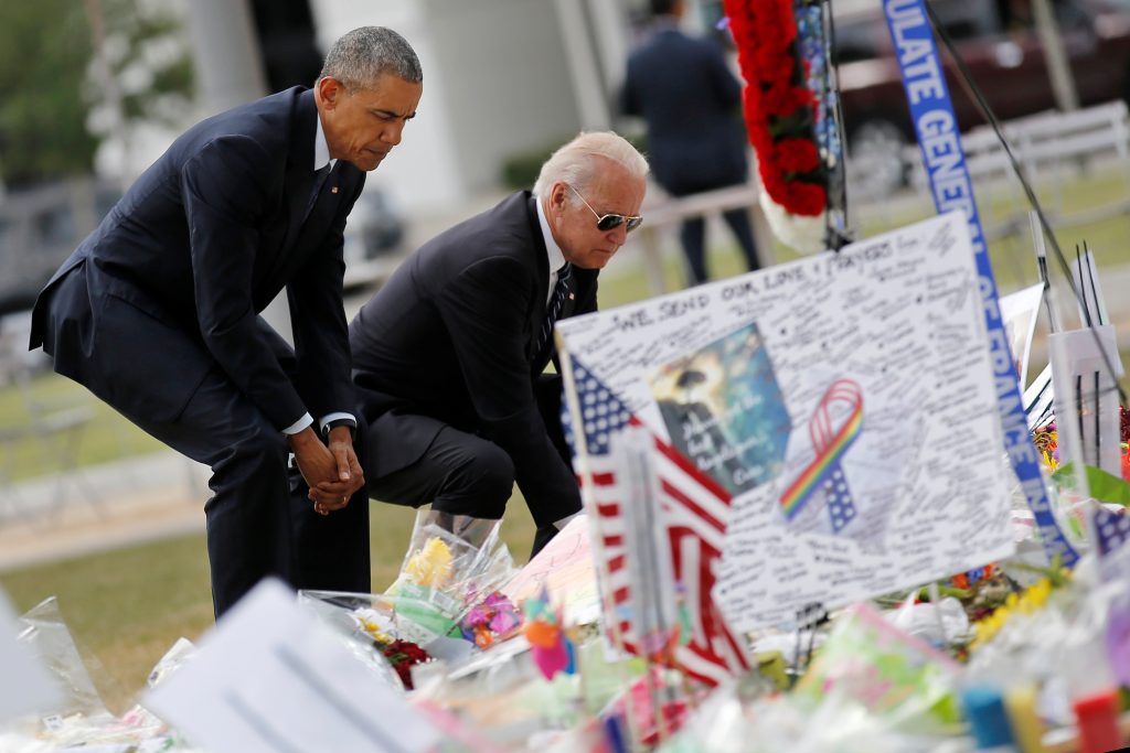 U.S. President Barack Obama (L) and Vice President Joe Biden pause as they place flowers at a makeshift memorial for shooting victims of the massacre at a gay nightclub in Orlando, Florida, U.S., June 16, 2016. Photo By Carlos Barria/Reuters 