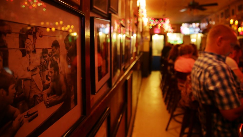 Photos of Muhammad Ali adorn the wall at Jimmy's Corner bar in New York, on June 5, 2016. Photo by Andi Wang/NewsHour Weekend