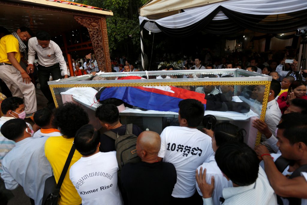 The body of Kem Ley, an anti-government figure and the head of a grassroots advocacy group "Khmer for Khmer", is carried by his relatives and supporters to put on a hearse during a funeral procession to carry his body to his hometown, in Phnom Penh July 24, 2016. REUTERS/Samrang Pring - RTSJD8Q