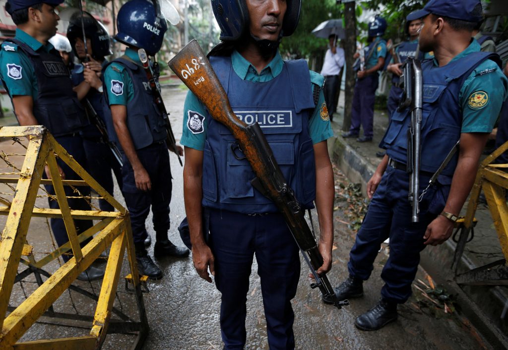 Policemen stand guard along a road leading to the Holey Artisan Bakery and the O'Kitchen Restaurant after gunmen attacked, in Dhaka, Bangladesh, July 3, 2016. Photo By Adnan Abidi/Reuters 