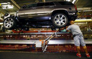 Mike Guillen works on the assembly line at the General Motors Assembly Plant in Arlington, Texas June 9, 2015. General Motors Co is raising the stakes on its bet that sales of fuel-thirsty sport utility vehicles will keep driving its global profits as Chinese and other markets sag. GM said on July 14, 2015 that it plans to spend $1.4 billion to modernize the factory in Arlington, Texas, that builds the Cadillac Escalade, Chevrolet Suburban and GMC Yukon sport utility vehicles. It's the largest single investment in a $5.4 billion, three-year plant upgrade program announced earlier this year. Picture taken June 9, 2015. To match Insight GM-SUVS/ REUTERS/Mike Stone