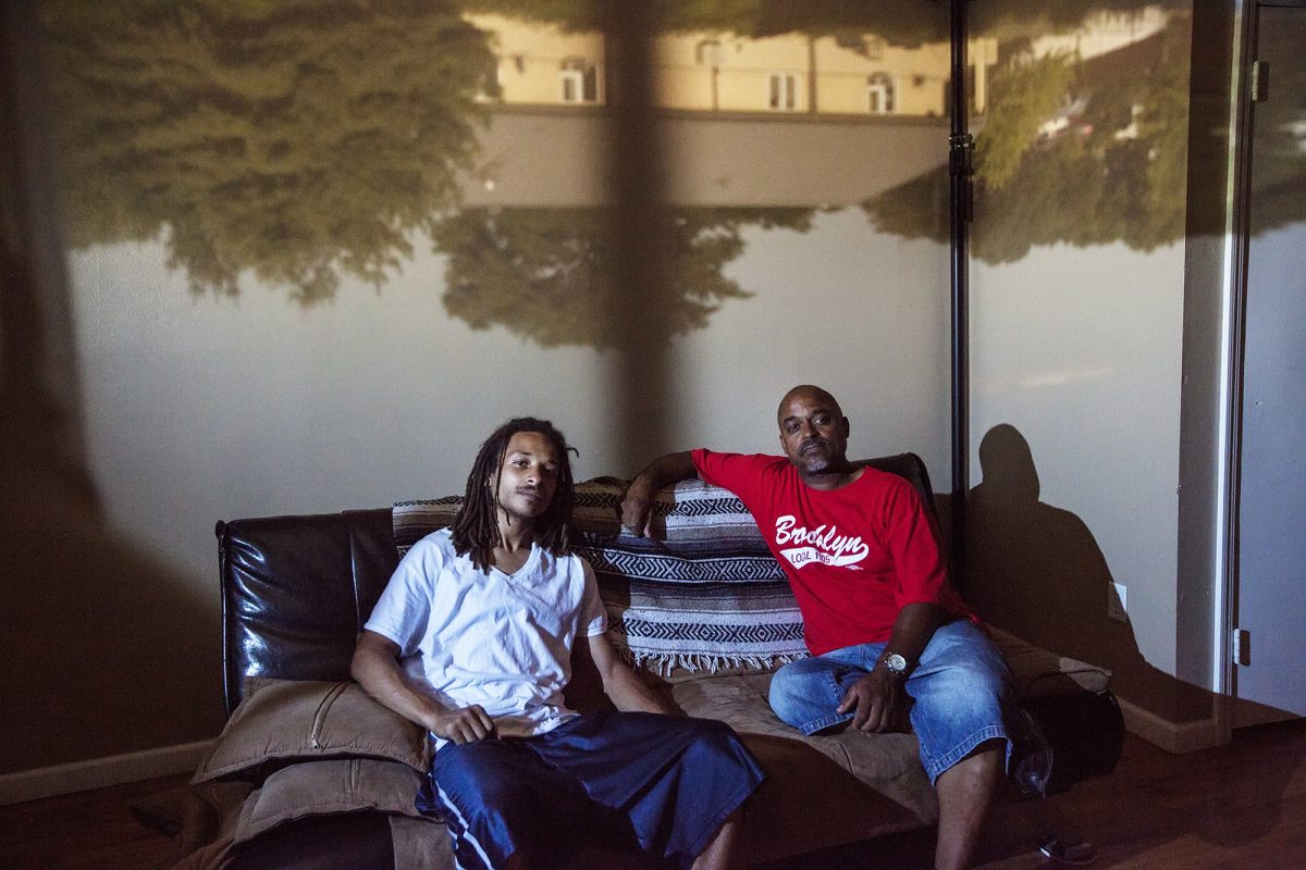 Michael Cathlin, 26, poses for a portrait with his step father, Michael Burke-Andrade, in East New York, NY on July 25, 2015. "Thankfully I walked in [the delivery room] right before my son started crying. So I was there for the whole thing but it was the fact that the mother didn't want me there." Photo by Phyllis Dooney