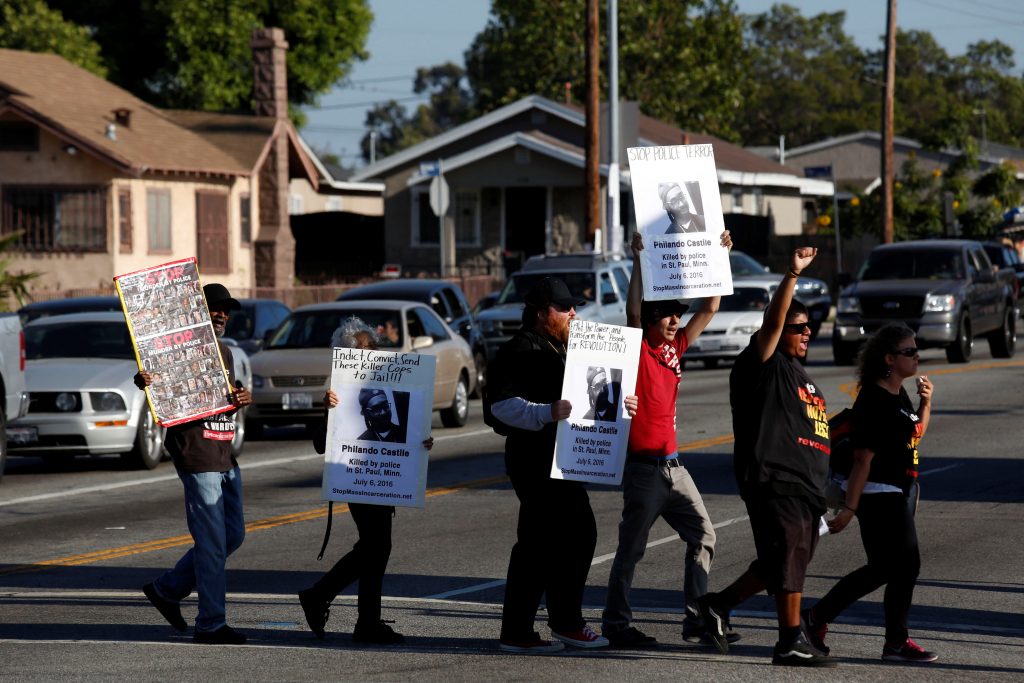 Activists hold signs of Philando Castile as they protest in Los Angeles, California, against the police shootings that lead to two deaths in Louisiana and Minnesota, respectively. Photo taken in July. Photo by Patrick T. Fallon/Reuters