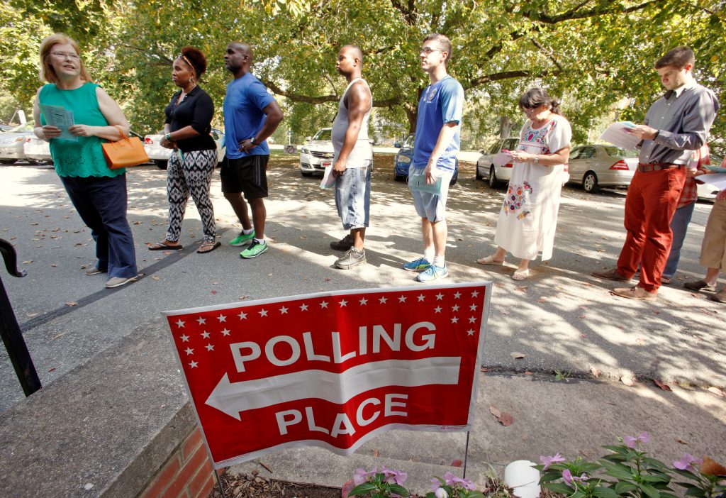People arrive to cast their ballot for 2016 elections at a polling station as early voting begins in North Carolina, in Ca...