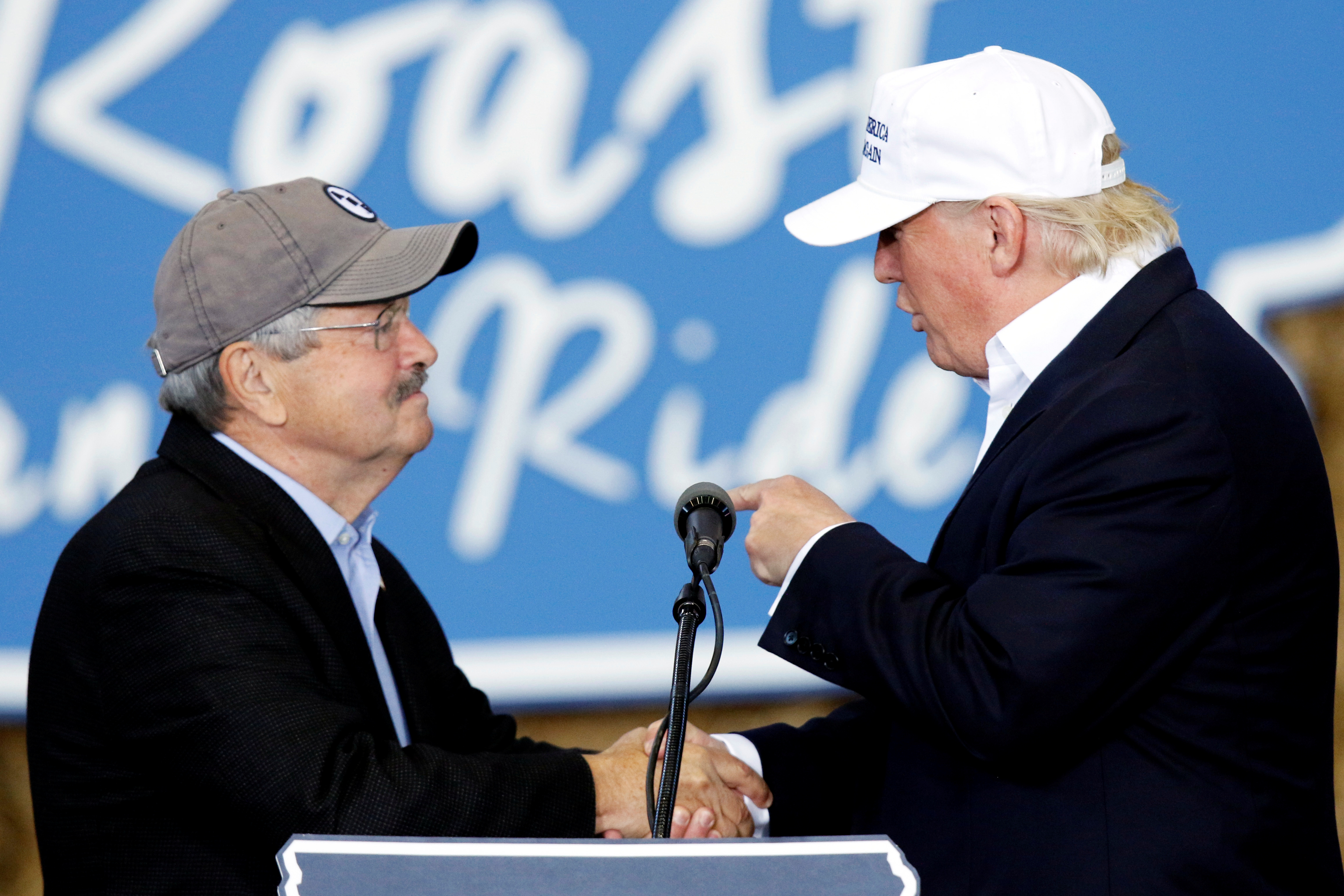 Republican presidential nominee Donald Trump meets Iowa Governor Terry Branstad as he speaks during Iowa Senator Joni Ernst's Roast and Ride at the Iowa State Fairgrounds in Des Moines August 27, 2016. REUTERS/Scott Morgan - RTX2NAYW