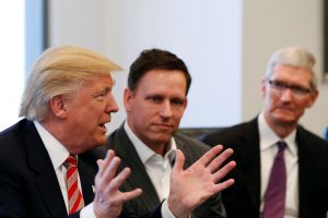 U.S. President-elect Donald Trump speaks as PayPal co-founder and Facebook board member Peter Thiel (center) and Apple Inc CEO Tim Cook look on during a meeting with technology leaders at Trump Tower in New York U.S., December 14, 2016. Photo by Shannon Stapleton/REUTERS
